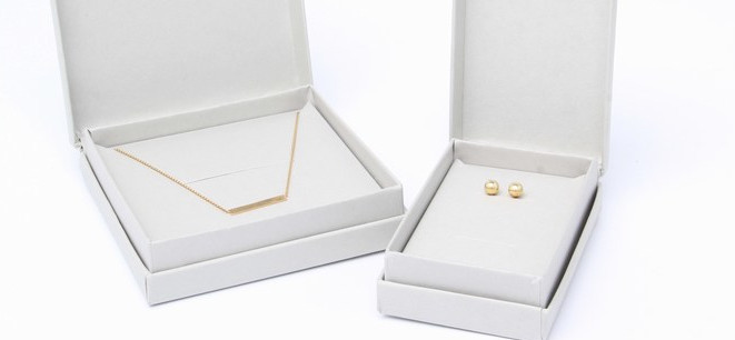 Dove grey earring box with gold earrings inside