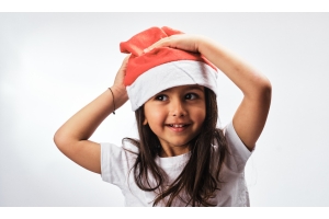 Girl in a santa hat and white tshirt 