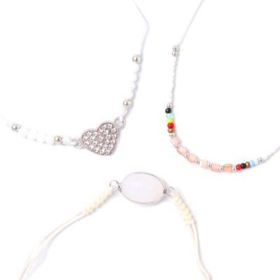 Card of 3 white bracelets with beads and charms