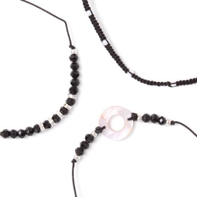 Card of 3 black corded bracelets with beads and charms