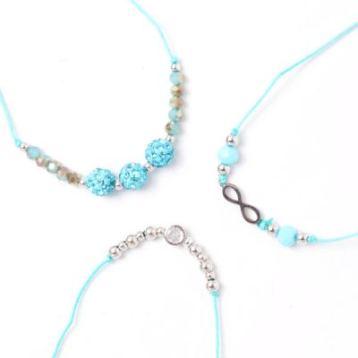Card of 3 turquoise corded bracelets with beads and charms