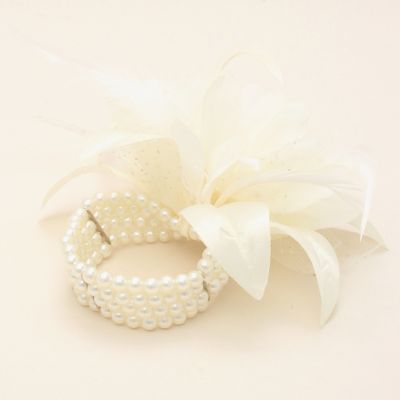 Cream flower corsage on a pearl bead bracelet.