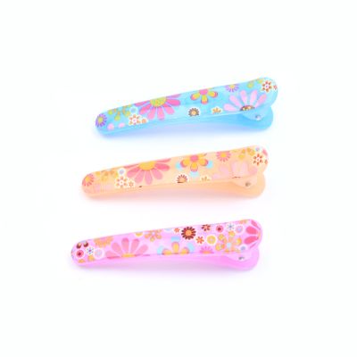Card of 4 floral printed plastic beak clips. 4.5cm