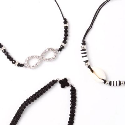 Card of 3 black corded bracelets with beads and charms