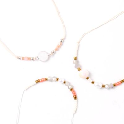 Card of 3 white and cream bracelets with beads and charms