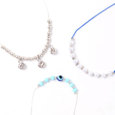 Card of 3 blue and white corded bracelets with beads and charms