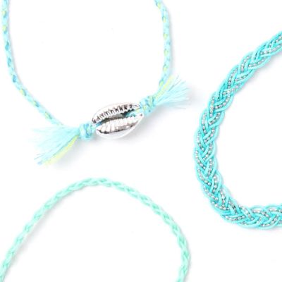 Card of 3 turquoise corded bracelets with shell charm