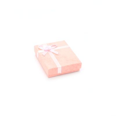 8x7x2cm. Pink gift box with ribbon detail.
