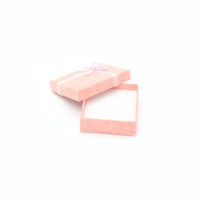 8x7x2cm. Pink gift box with ribbon detail.