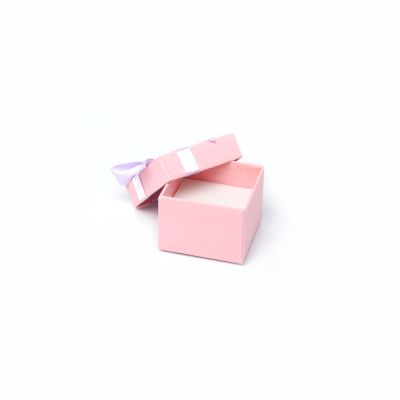 Ring box. 5x5x3.5cm. Textured pink gift box with lilac bow.
