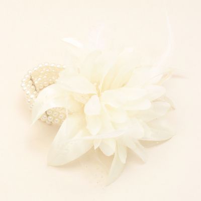 Cream flower corsage on a pearl bead bracelet.