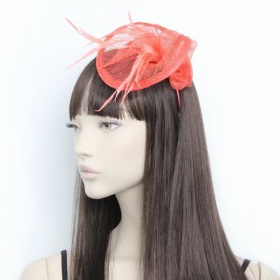 © Style Eliza. Coral curled fascinator on an aliceband