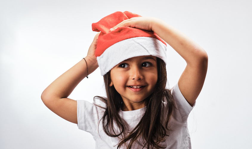 Girl in a santa hat and white tshirt 