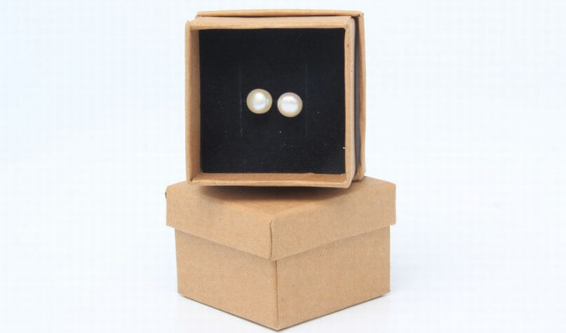 Pearl earrings in brown kraft earring box with black velvet insert